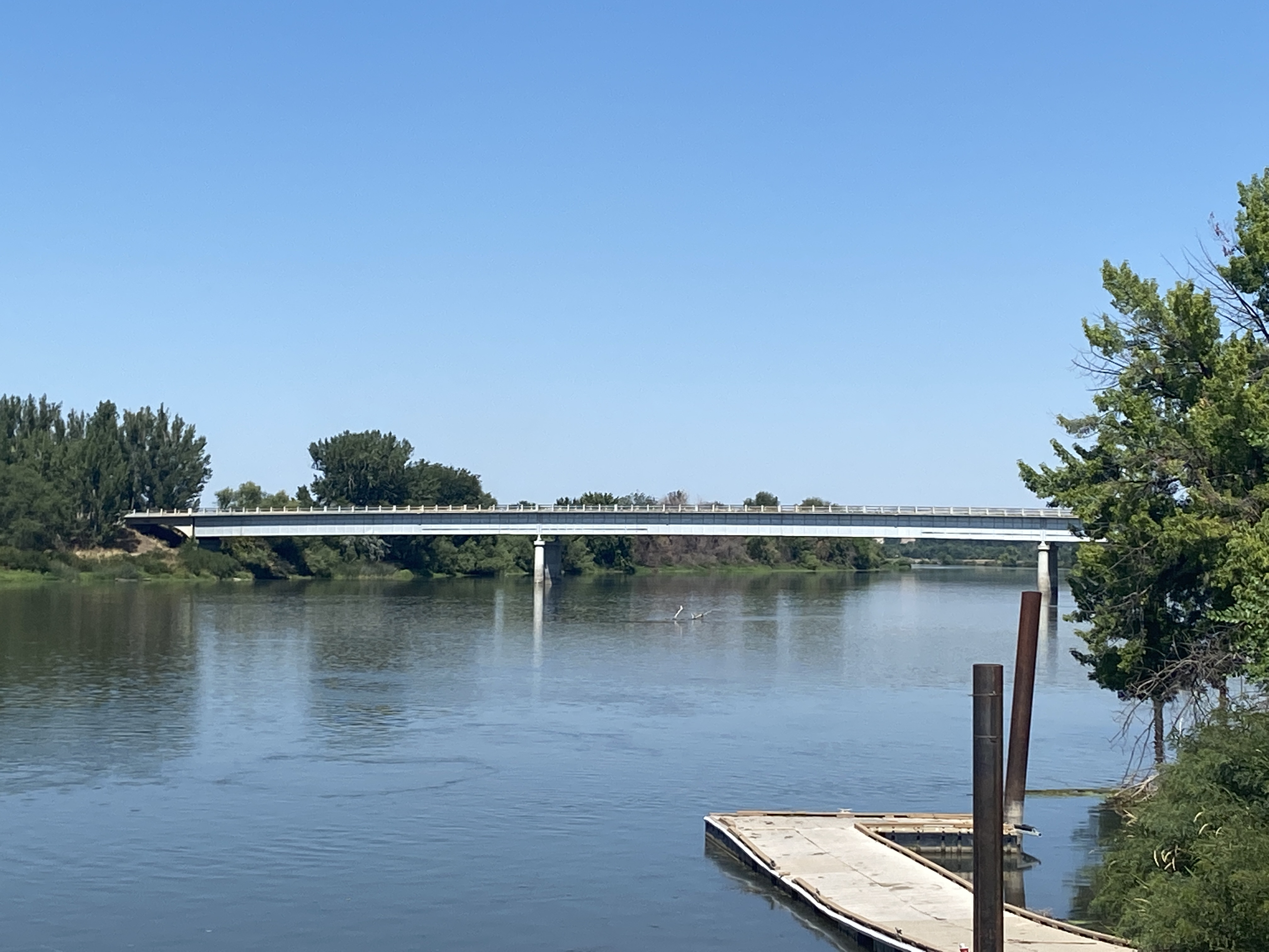View from water level of SH-52 bridge over Snake River. A floating dock is in the foreground.