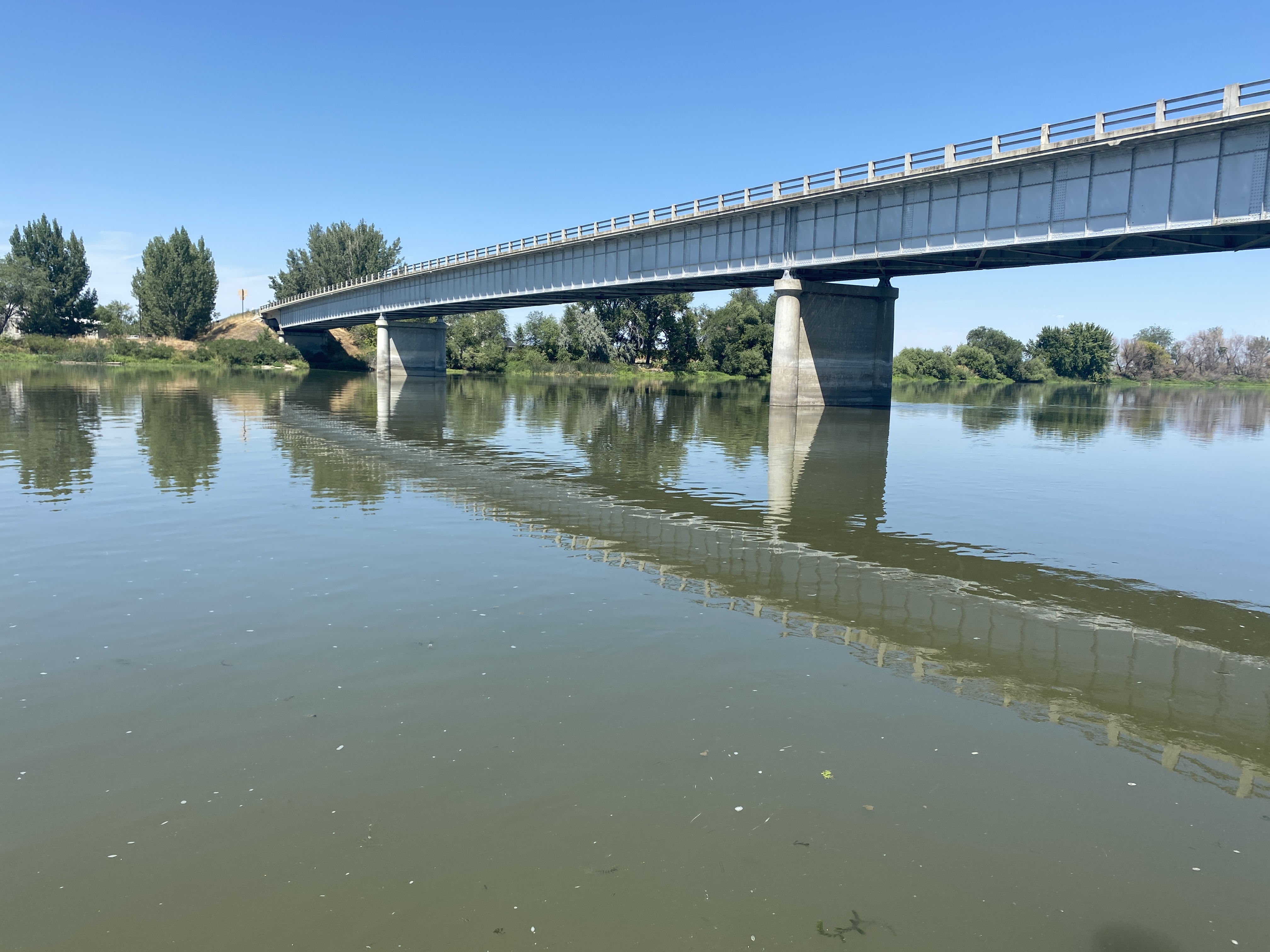 View of SH-52 bridge over Snake River from the water's edge.
